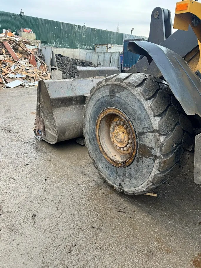 A dump truck is parked in a lot.