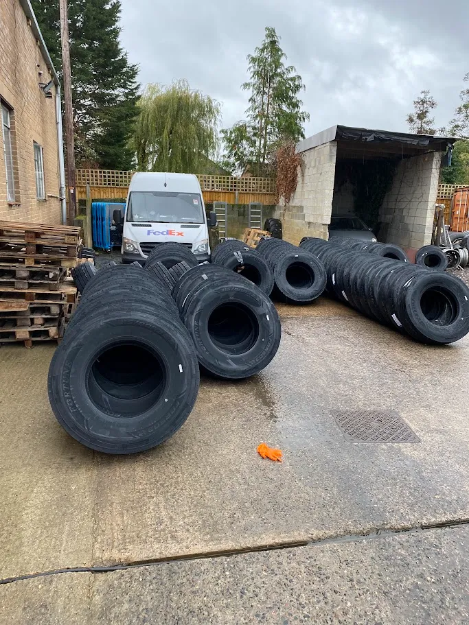A bunch of tires that are laying on the ground.