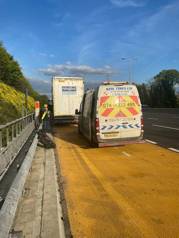A couple of trucks that are on the side of the road.