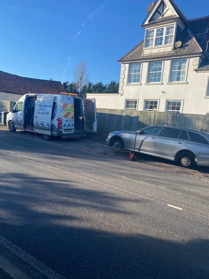A moving truck is parked in front of a house.